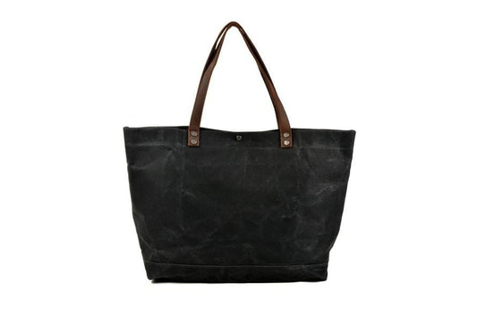 Túi tote đeo vai bằng vải canvas màu đen có nhiều ngăn.